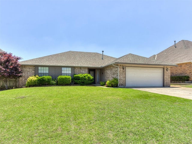 312 Carlsbad Ct, Yukon, OK 73099 - ranch-style home featuring a front lawn, an attached garage, driveway, and brick siding