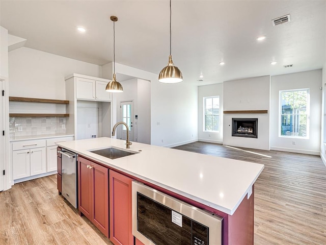 29612 Memory Ln, Norman, OK 73072 - kitchen featuring a sink, light wood-style flooring, open shelves, healthy amount of natural light, and recessed lighting
