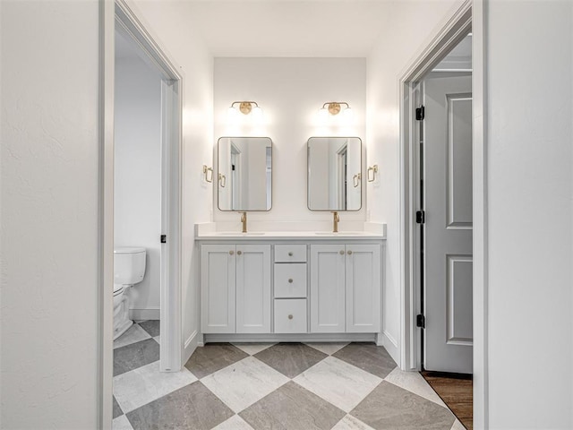 29612 Memory Ln, Norman, OK 73072 - bathroom with double vanity, toilet, and baseboards