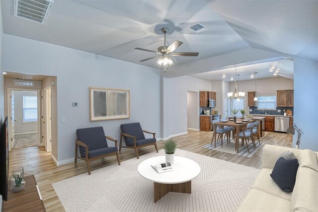 20101 Park Ln, Harrah, OK 73045 - living room with light wood finished floors, vaulted ceiling, baseboards, and a chandelier