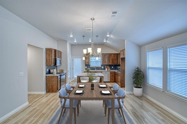 20101 Park Ln, Harrah, OK 73045 - dining space featuring light wood-style floors, a chandelier, baseboards, and vaulted ceiling