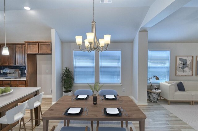 20101 Park Ln, Harrah, OK 73045 - dining area featuring a chandelier, light wood-style floors, healthy amount of natural light, baseboards, and lofted ceiling