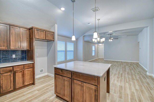 20101 Park Ln, Harrah, OK 73045 - kitchen featuring light wood-style flooring, backsplash, lofted ceiling, a chandelier, and hanging light fixtures