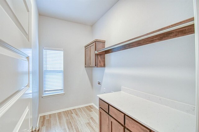 20101 Park Ln, Harrah, OK 73045 - laundry area with washer hookup, cabinet space, light wood-style flooring, and baseboards