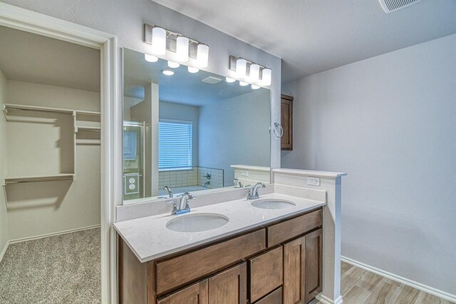 20101 Park Ln, Harrah, OK 73045 - bathroom with baseboards, double vanity, a walk in closet, and a shower with door