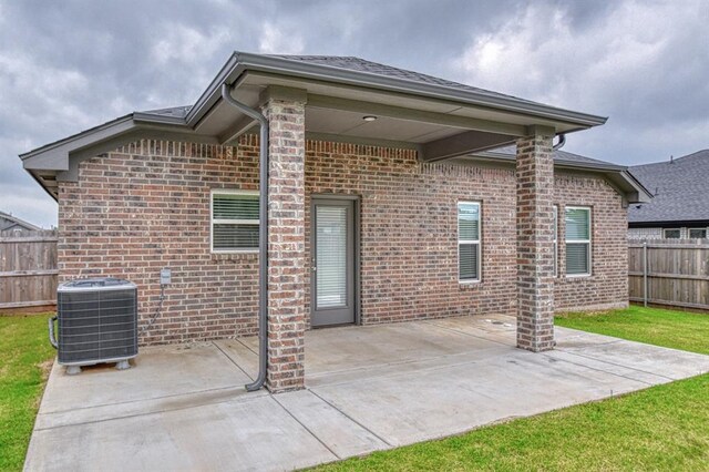 20101 Park Ln, Harrah, OK 73045 - rear view of house featuring central AC, brick siding, and a patio