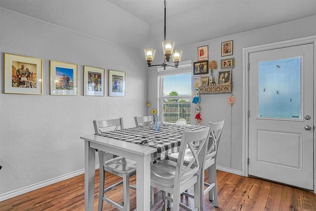1537 Avalon Dr, Altus, OK 73521 - dining room featuring a chandelier, wood finished floors, and baseboards