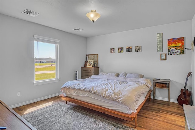 1537 Avalon Dr, Altus, OK 73521 - bedroom featuring baseboards and wood finished floors