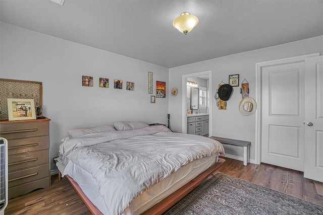 1537 Avalon Dr, Altus, OK 73521 - bedroom with wood finished floors, baseboards, and ensuite bathroom