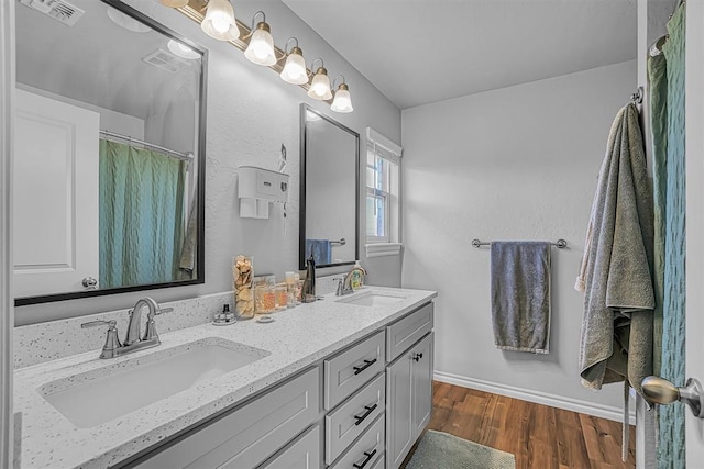 1537 Avalon Dr, Altus, OK 73521 - full bath featuring wood finished floors, double vanity, and baseboards