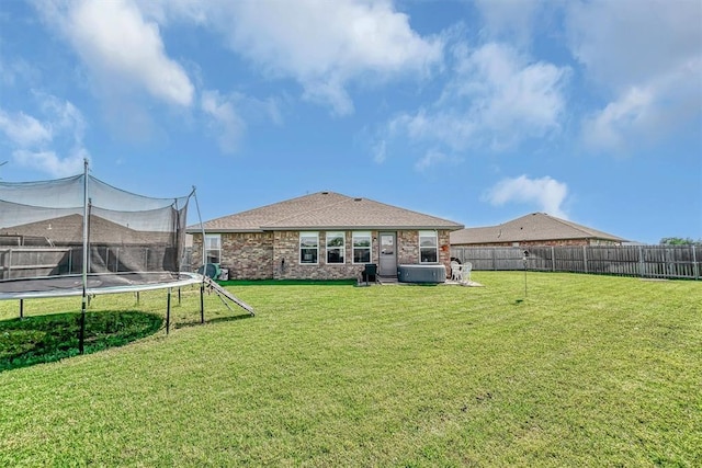 1537 Avalon Dr, Altus, OK 73521 - rear view of property featuring a trampoline, brick siding, a shingled roof, and central AC