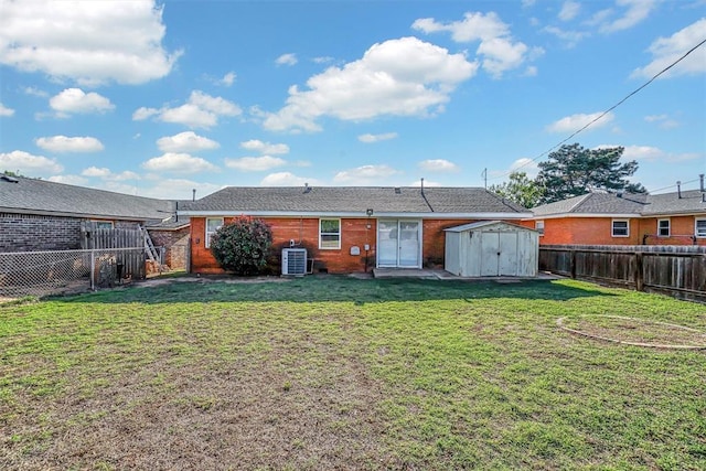 rear view of house featuring a storage unit, an outbuilding, and cooling unit
