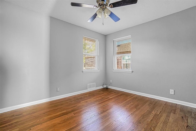 unfurnished room with wood finished floors, baseboards, and ceiling fan