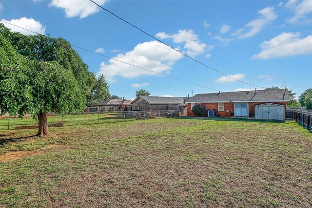 view of yard featuring a storage shed and an outdoor structure