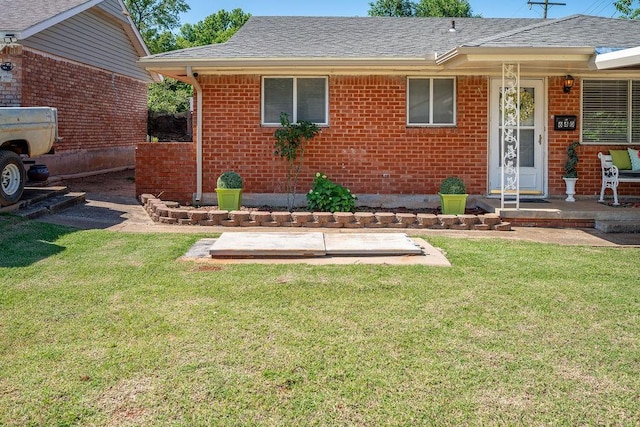 640 SW 1st Pl, Moore, OK 73160 - view of front of home featuring brick siding, a front lawn, and roof with shingles