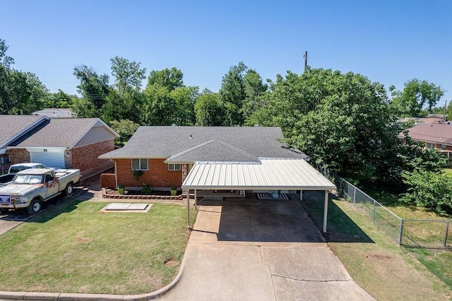 640 SW 1st Pl, Moore, OK 73160 - view of front facade with concrete driveway, brick siding, and an attached carport