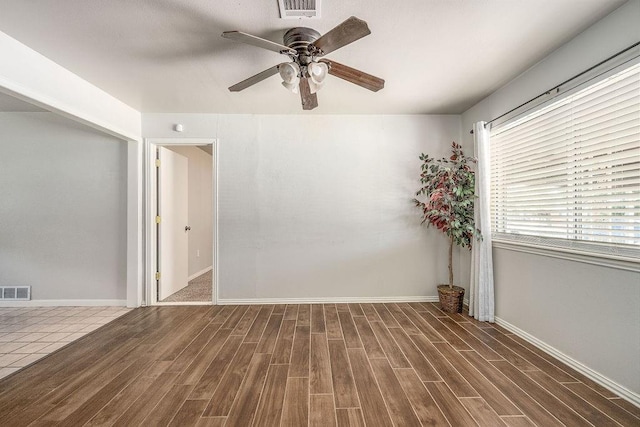 640 SW 1st Pl, Moore, OK 73160 - spare room with wood finished floors, ceiling fan, and baseboards