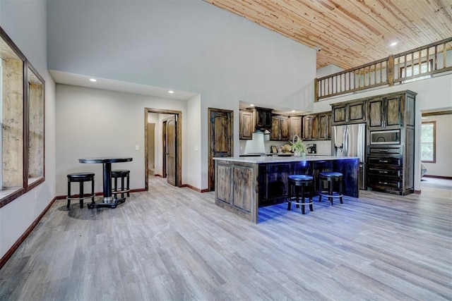 4575 Hidden Path, Kingston, OK 73439 - kitchen featuring high vaulted ceiling, appliances with stainless steel finishes, baseboards, a center island, and light countertops