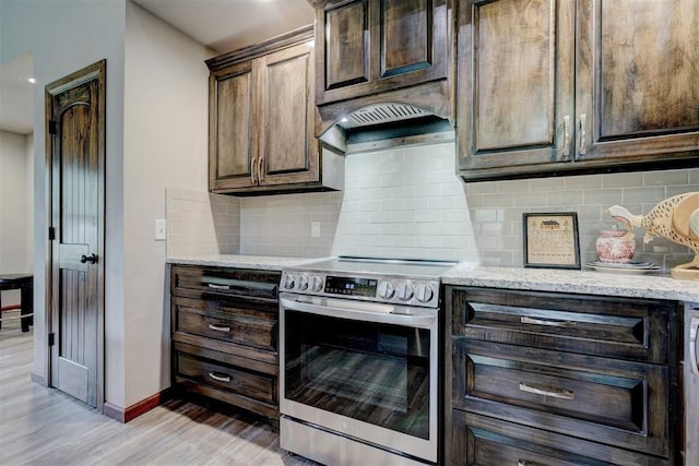 4575 Hidden Path, Kingston, OK 73439 - kitchen with electric range, light wood-type flooring, baseboards, dark brown cabinetry, and light stone countertops