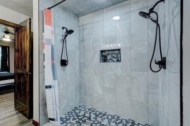 4575 Hidden Path, Kingston, OK 73439 - ensuite bathroom with tiled shower and wood finished floors