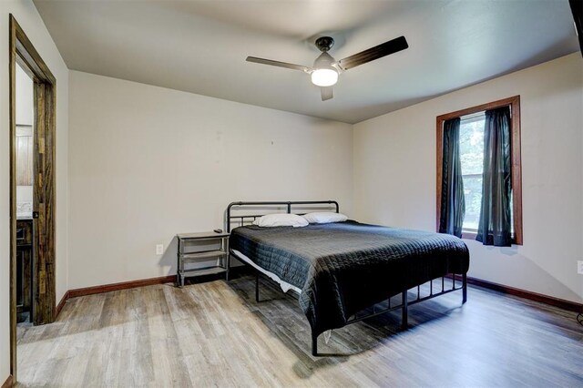4575 Hidden Path, Kingston, OK 73439 - bedroom with light wood-style floors, baseboards, and a ceiling fan