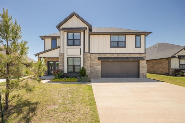 view of front of house featuring stone siding, driveway, an attached garage, and a front lawn