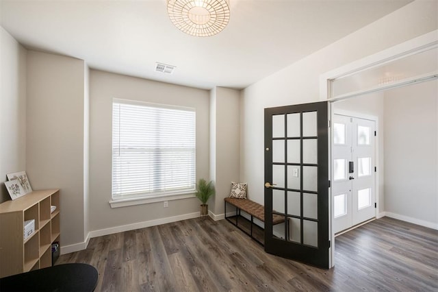 doorway featuring wood finished floors and baseboards