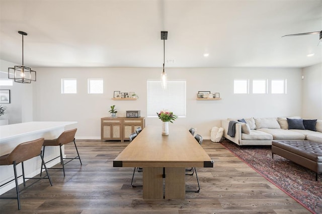 dining area featuring dark wood finished floors and baseboards