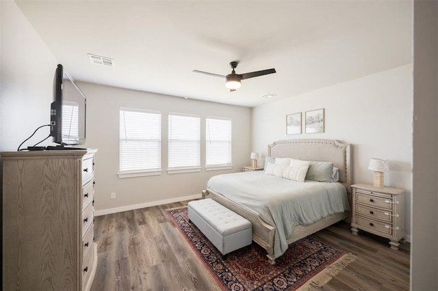 bedroom featuring dark wood finished floors, baseboards, and a ceiling fan