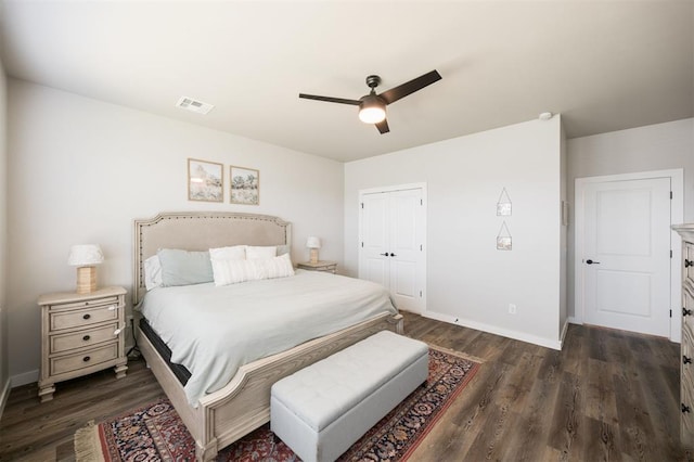 bedroom featuring dark wood-type flooring, baseboards, and a closet