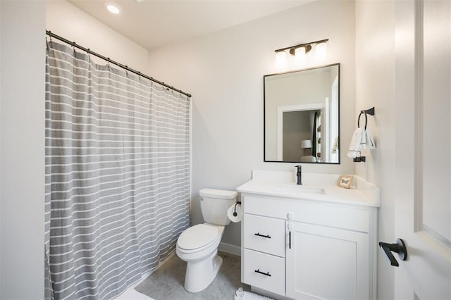 bathroom featuring toilet, vanity, and a shower with curtain
