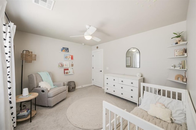bedroom with light colored carpet, ceiling fan, and baseboards