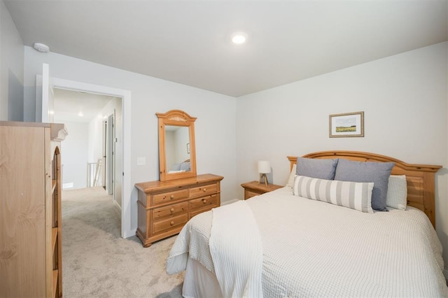 bedroom with light colored carpet and recessed lighting