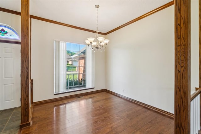 entrance foyer with wood finished floors, ornamental molding, a chandelier, and baseboards