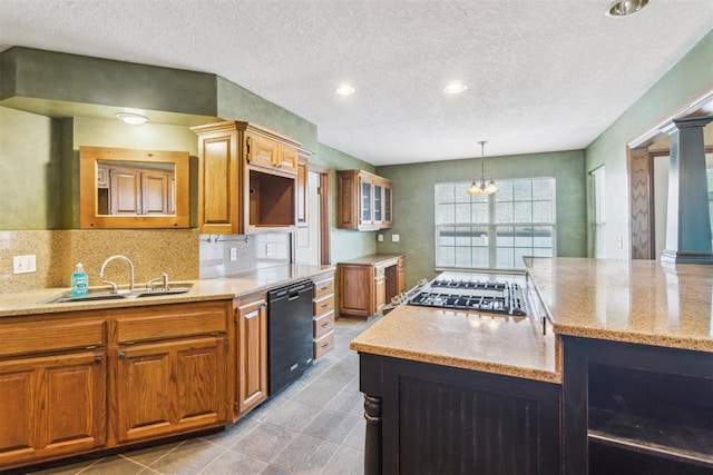 kitchen with dishwasher, a sink, a textured ceiling, light stone countertops, and brown cabinets