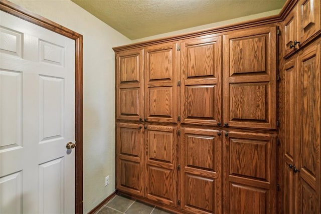 detailed view of a textured ceiling and baseboards