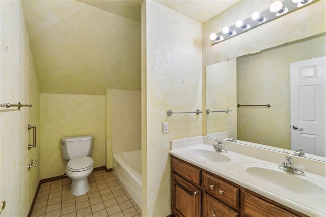 bathroom featuring toilet, tile patterned floors, a tub to relax in, and double vanity