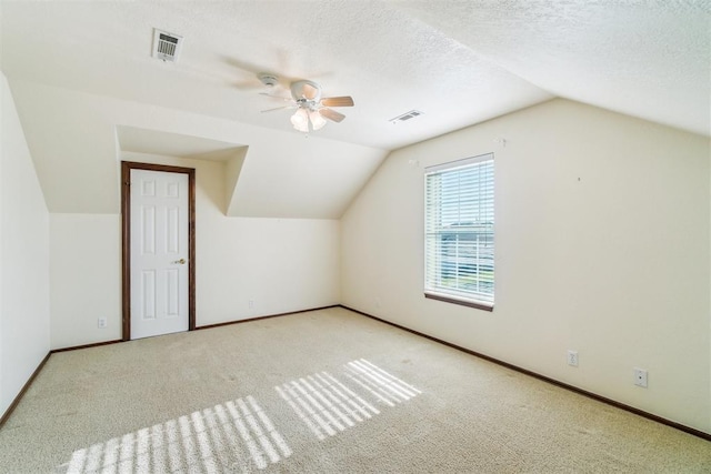 bonus room featuring lofted ceiling, a ceiling fan, carpet, and baseboards