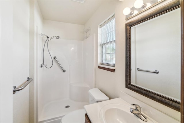 full bath with a shower, vanity, and toilet
