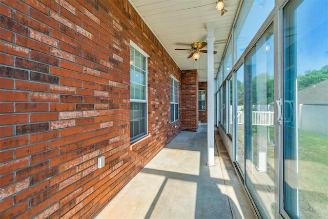unfurnished sunroom featuring a ceiling fan