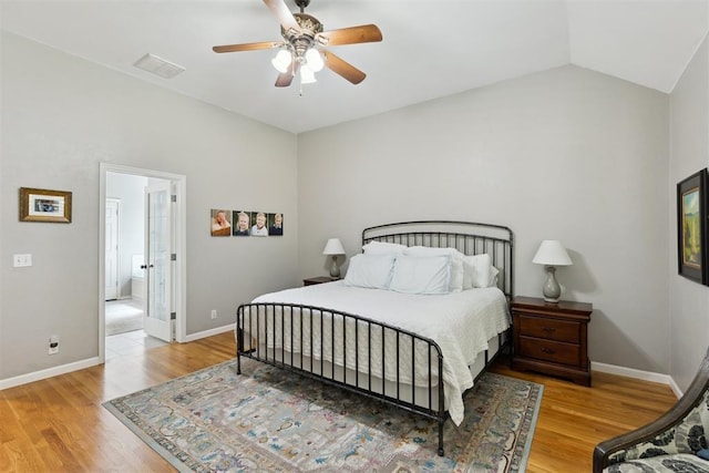 bedroom with wood finished floors, baseboards, a ceiling fan, and vaulted ceiling