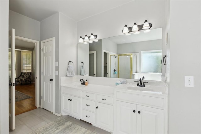 full bathroom featuring ensuite bathroom, a stall shower, and double vanity