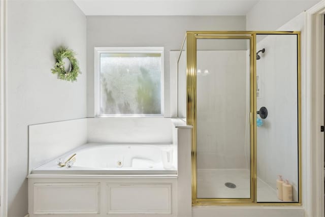 bathroom with a stall shower and a jetted tub