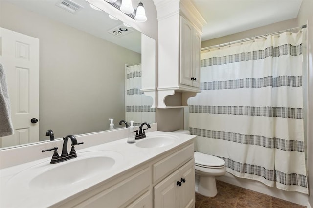 bathroom with double vanity, toilet, and tile patterned flooring