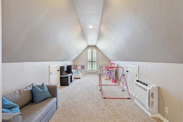 game room featuring carpet floors, vaulted ceiling, heating unit, and baseboards