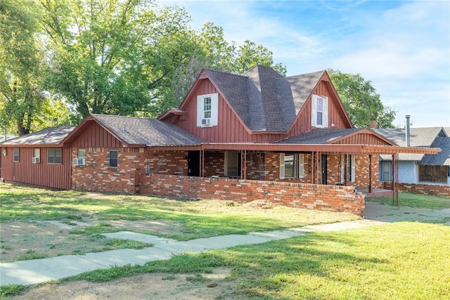 view of front of property with a front lawn, covered porch, board and batten siding, and a shingled roof