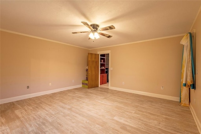 spare room featuring ceiling fan, light wood finished floors, ornamental molding, and baseboards