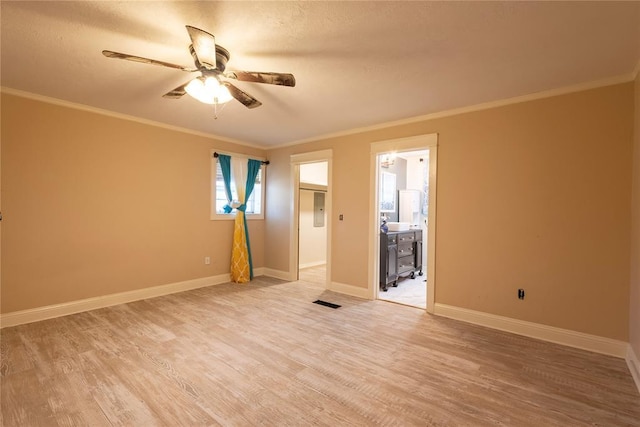 unfurnished room with a ceiling fan, light wood finished floors, crown molding, baseboards, and a textured ceiling
