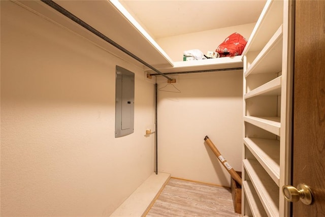 spacious closet featuring electric panel and light wood finished floors