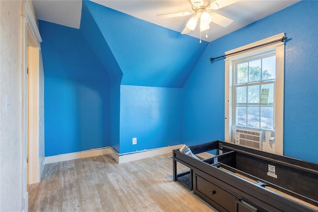 playroom featuring wood finished floors, lofted ceiling, a ceiling fan, a textured wall, and baseboards